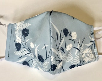 3 layers- Wedding, Party, etc. Polyester outside fabric and cotton other side fabric Face Mask with pocket. Washable. USA.Floral blue