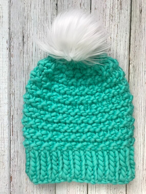 wool hat with fur pom pom