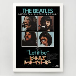May include: A framed poster of The Beatles, featuring four images of the band members on a black background. The poster includes the text "THE BEATLES" and "Let it be", with Japanese text below. The poster is in a white frame.