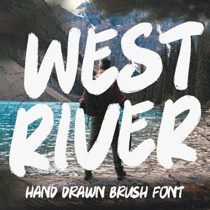 May include: Hand-drawn brush font design with the words "WEST RIVER" in white against a backdrop of a mountain lake and forest. The font is bold and has a rough, textured look.