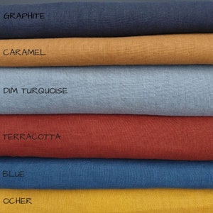 May include: Six fabric swatches stacked on top of each other. The swatches are in the following colors from top to bottom: graphite, caramel, dim turquoise, terracotta, blue, and ocher.