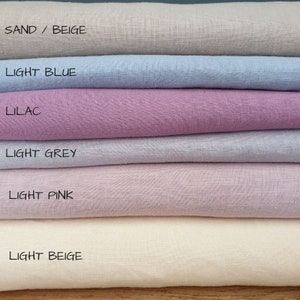 May include: Six fabric swatches stacked on top of each other. The swatches are in the following colors from top to bottom: sand/beige, light blue, lilac, light grey, light pink, and light beige.