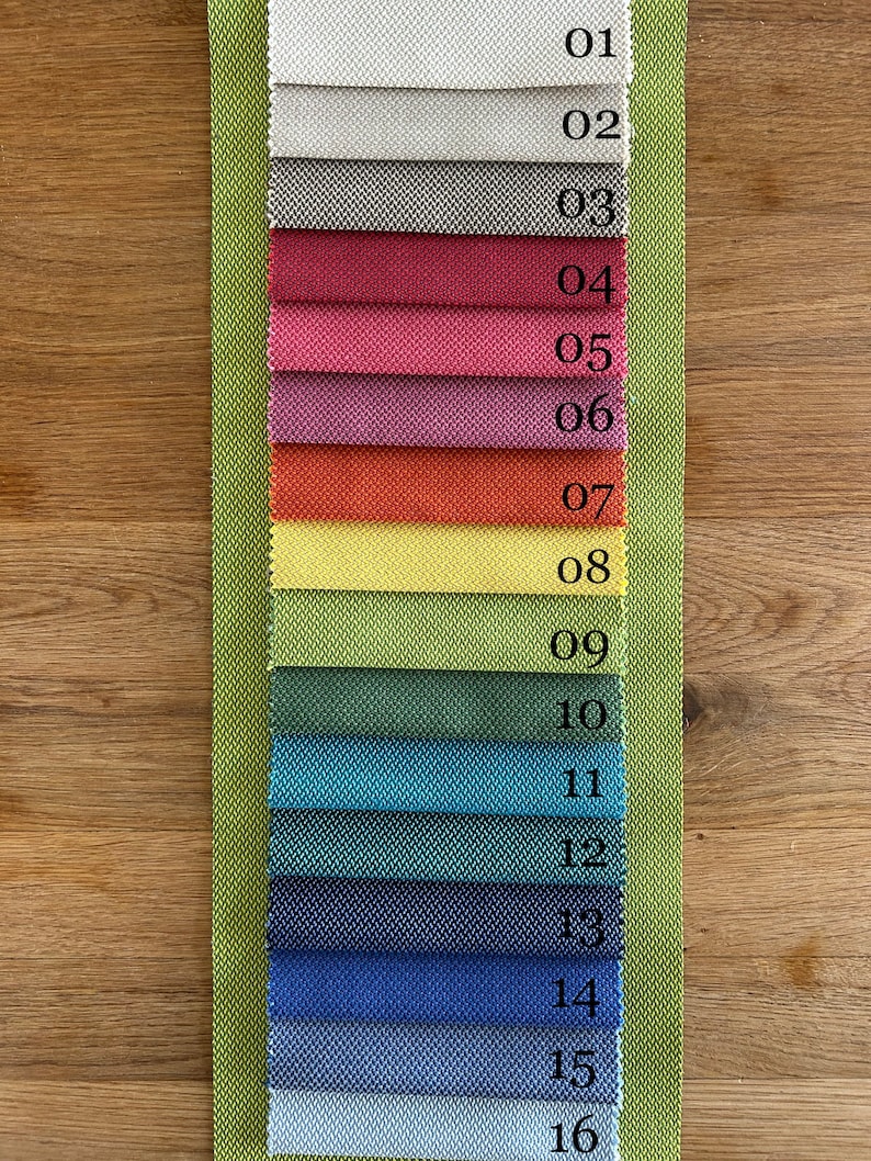 May include: A fabric swatch card displaying 16 different fabric samples. The samples are numbered 01 to 16. The fabric samples are in a range of colours and textures.