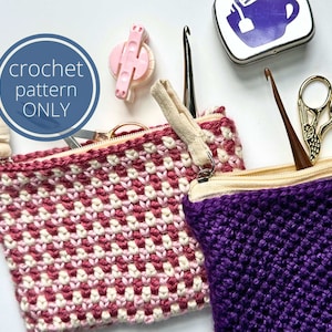 May include: Two zippered pouches with crochet texture, one in a pink and white checkered pattern and one in solid purple. Includes a pink pom-pom maker, metal crochet hooks, and gold-toned scissors. Text on the image reads: crochet pattern ONLY.