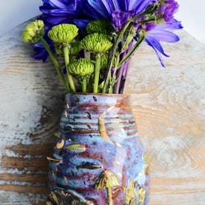 Handmade ceramic wall vase with gold accents and a moonlight forest design perfect for dried or fresh floral arrangements