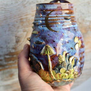 This gold-accented vase is a perfect gift for housewarmings, weddings, or anyone who appreciates one-of-a-kind ceramic art with woodland and lunar themes.