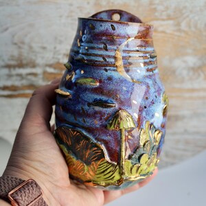 The moon and stars motif, along with forest-inspired textures and colors, make it a charming addition to modern or rustic interiors.