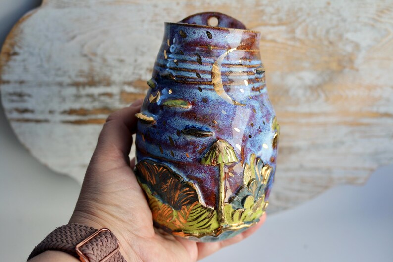 The moon and stars motif, along with forest-inspired textures and colors, make it a charming addition to modern or rustic interiors.