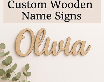May include: A custom wooden name sign in a cursive font, spelling "Olivia". The sign is made of light-colored wood and is displayed against a white background. The text "Custom Wooden Name Signs" is above the name.