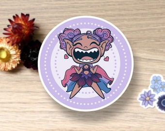 May include: A sticker featuring a cartoon illustration of a purple-haired fairy with a big smile and a flower crown. The fairy is wearing a purple and blue dress with a flower design. The sticker is on a white background with a purple circle around the fairy.