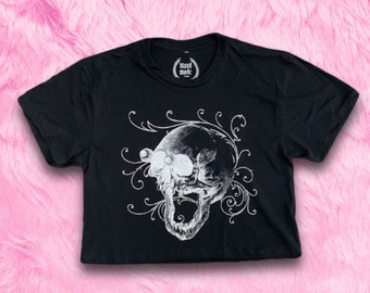 May include: Black cropped t-shirt with a white skull graphic and floral design. The shirt has the text "blood made" on the tag.