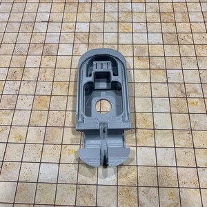May include: A gray 3D printed model of a spaceship with a cockpit and a rear thruster.