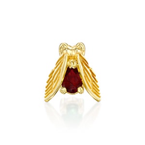 May include: Gold bee charm with a red gemstone. The bee has detailed wings and a textured body.