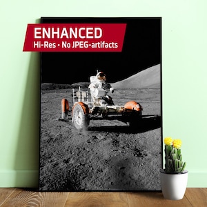 May include: Black and white canvas print of an astronaut driving a lunar rover on the moon. The rover has orange fenders and white wheels. The print includes the text "ENHANCED Hi-Res • No JPEG-artifacts" in a red banner.