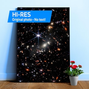 May include: A rectangular wall art print featuring a deep space galaxy image with numerous stars, glowing nebulae, and distant clusters in shades of black, white, and orange. The print includes a blue banner with the text HI-RES Original photo No text!