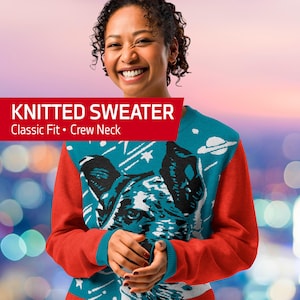 May include: A teal blue knitted sweater with a red and white dog graphic and stars. The sweater has a crew neck and a classic fit. The text "KNITTED SWEATER" and "Classic Fit • Crew Neck" is printed in red on a white background.
