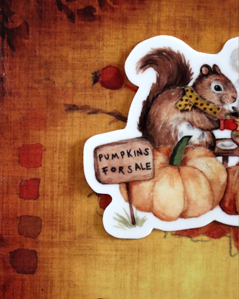 May include: A watercolor illustration of a squirrel selling pumpkins. The squirrel is wearing a yellow and red polka dot scarf and holding a sign that says "Pumpkins for Sale".