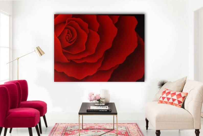 May include: A close-up of a single red rose with a deep red color and soft, velvety petals.