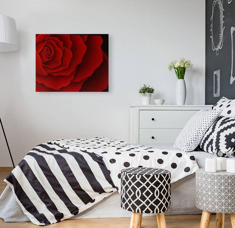 May include: A close-up of a red rose with a soft, velvety texture. The petals are arranged in a spiral pattern, creating a beautiful and delicate design.