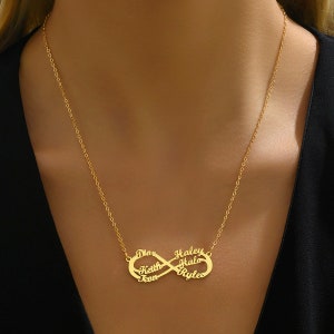 May include: Gold infinity necklace with five names: 'Diaz', 'Heath', 'Leon', 'Haley', and 'Ryles'.