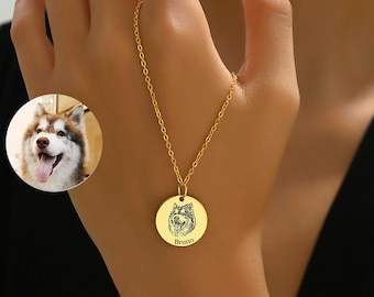 Può includere: Collana d'oro con un ciondolo rotondo con un'immagine incisa in bianco e nero del muso di un cane e il nome "Bruno" sotto.