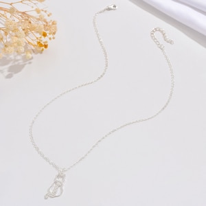 May include: A silver chain necklace with a pendant that says "Mommy" in a stylized font.