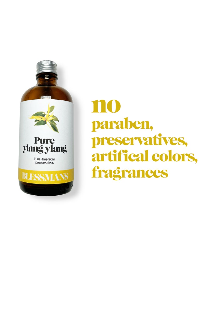 May include: A brown glass bottle with a silver lid, labeled "Pure ylang ylang" and "Blessmans". The bottle contains a natural essential oil. The text "no paraben, preservatives, artificial colors, fragrances" is written in yellow on a white background.