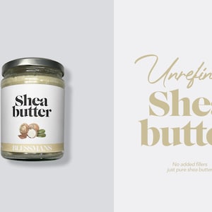 May include: A glass jar of unrefined shea butter with a white label that says "Shea butter" and has a drawing of shea nuts. The label also says "Blessmans". The background is white.
