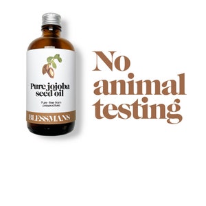 May include: A brown glass bottle with a silver lid, labeled "Pure jojoba seed oil" and "Blessmans". The bottle is on a white background with the text "No animal testing" in brown letters.
