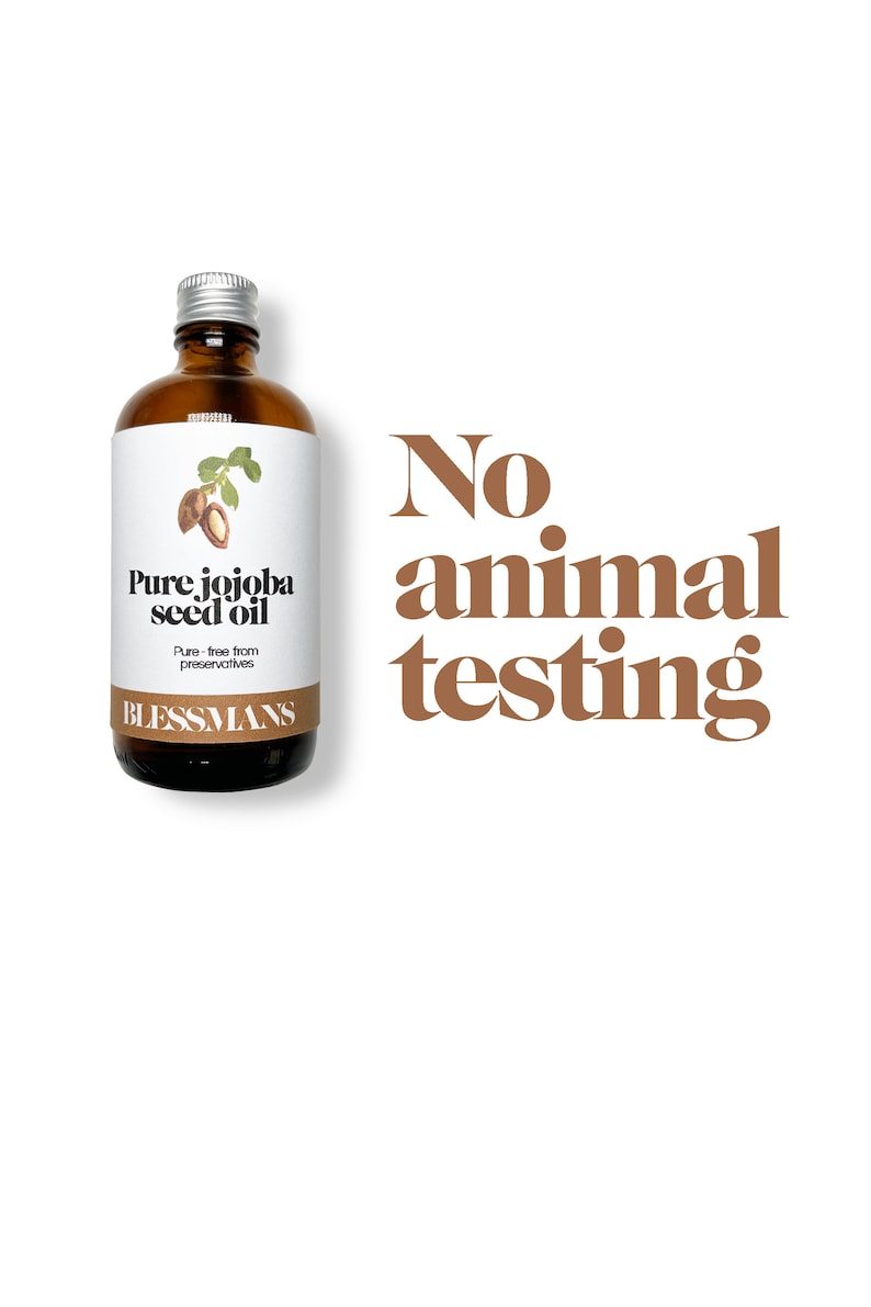 May include: A brown glass bottle with a silver lid, labeled "Pure jojoba seed oil" and "Blessmans". The bottle is on a white background with the text "No animal testing" in brown letters.