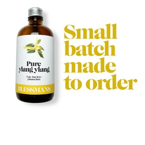 May include: A brown glass bottle with a silver lid, labeled "Pure ylang ylang" and "Blessmans". The bottle is filled with a clear liquid. The text "Small batch made to order" is written in yellow letters on a white background.
