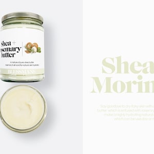 May include: A glass jar of shea butter with rosemary and almond oil. The jar has a white label with the text "Shea + Rosemary Butter" and "A mixture of pure shea butter, rosemary & almond for natural skin hydration. BLESSLANS".