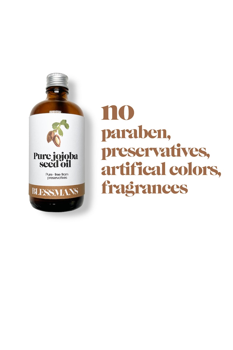 May include: A brown glass bottle with a silver lid containing pure jojoba seed oil. The label reads "Pure jojoba seed oil" and "Pure - free from preservatives". The bottle is sitting on a white background with the text "no paraben, preservatives, artificial colors, fragrances" in brown text.