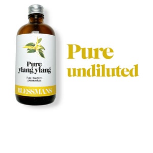 May include: A brown glass bottle with a silver lid, labeled "Pure ylang ylang" and "Pure - free from preservatives" with a small illustration of a flower. The bottle is labeled "Blessmans" and the text "Pure undiluted" is in large yellow letters.