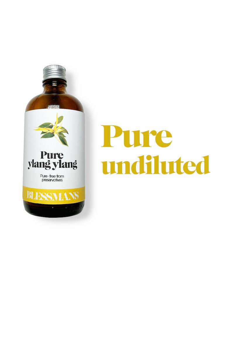May include: A brown glass bottle with a silver lid, labeled "Pure ylang ylang" and "Pure - free from preservatives" with a small illustration of a flower. The bottle is labeled "Blessmans" and the text "Pure undiluted" is in large yellow letters.