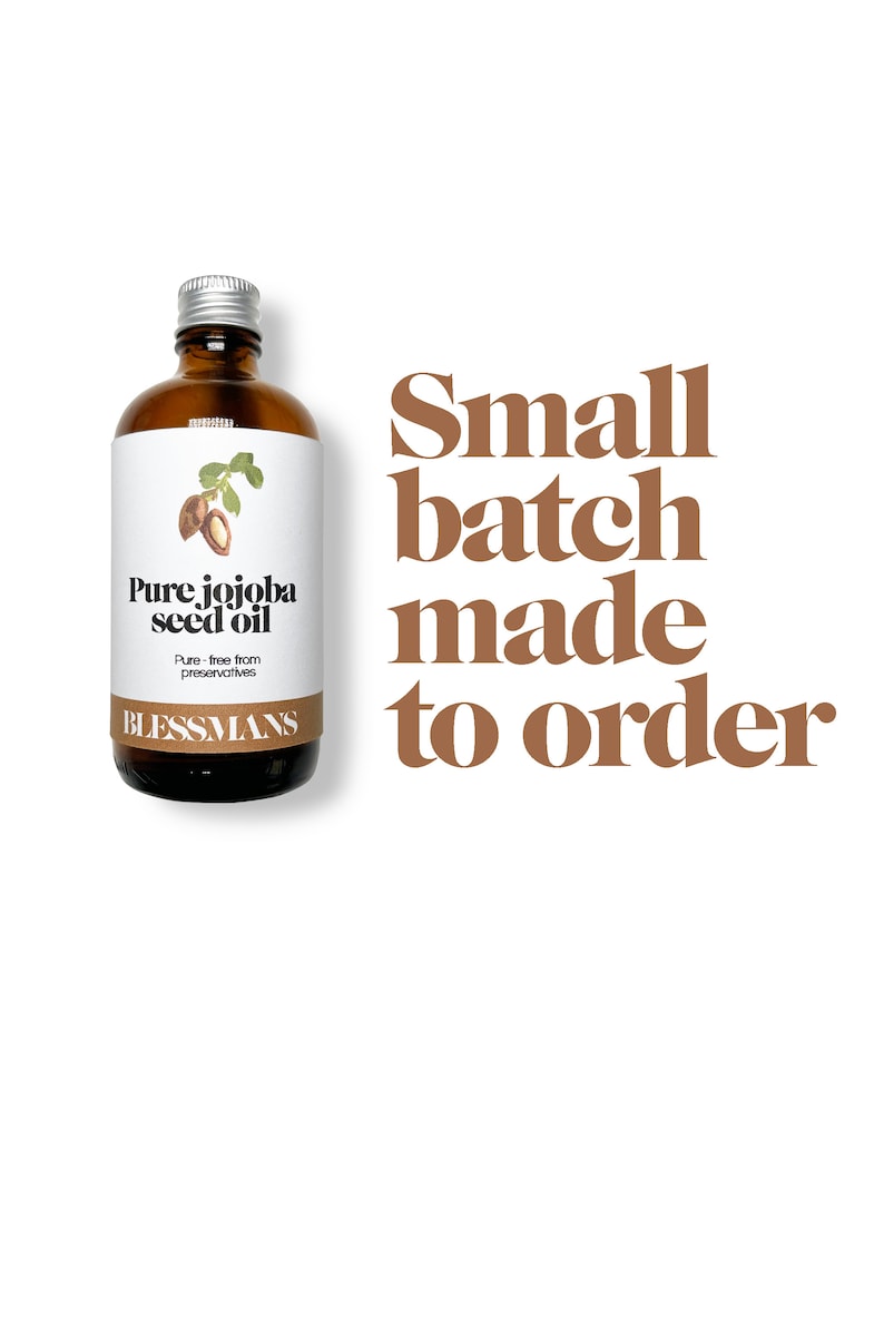 May include: A clear glass bottle with a silver lid filled with jojoba seed oil. The label reads "Pure jojoba seed oil" and "Pure - free from preservatives". The bottle is labeled "Blessmans". The text "Small batch made to order" is written in brown text on a white background.