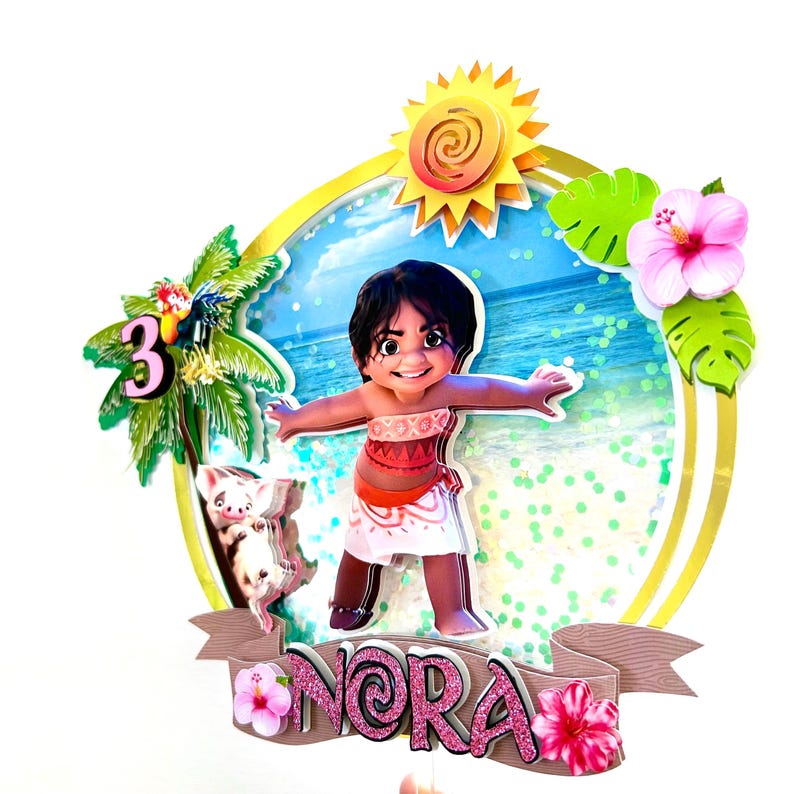 May include: A pink and white cake topper featuring Moana from Disney's Moana, a pig, a palm tree, a sun, and the name "Nora".