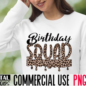 May include: White sweatshirt with the text "Birthday Squad" in black lettering. The letters are outlined with a leopard print pattern and have a dripping effect.