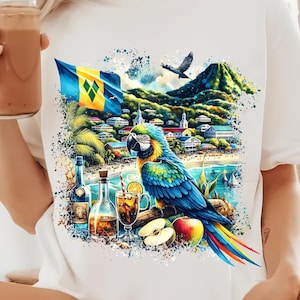 May include: White t-shirt with a colorful graphic design featuring a parrot, a tropical island scene, and a flag of Saint Lucia. The design includes a beach, palm trees, and a mountain.
