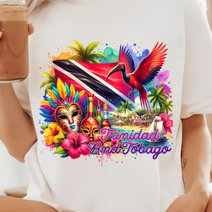 May include: White t-shirt with a colourful design featuring the flag of Trinidad and Tobago, a red bird, carnival masks, and the text "Trinidad And Tobago".