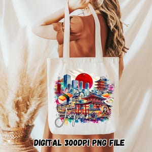 May include: White tote bag featuring a colorful watercolor design of Japanese landmarks, including a red sun, pagodas, and cityscapes. The word "Japan" is written in cursive. The bottom of the bag has the text "DIGITAL 300DPI PNG FILE".