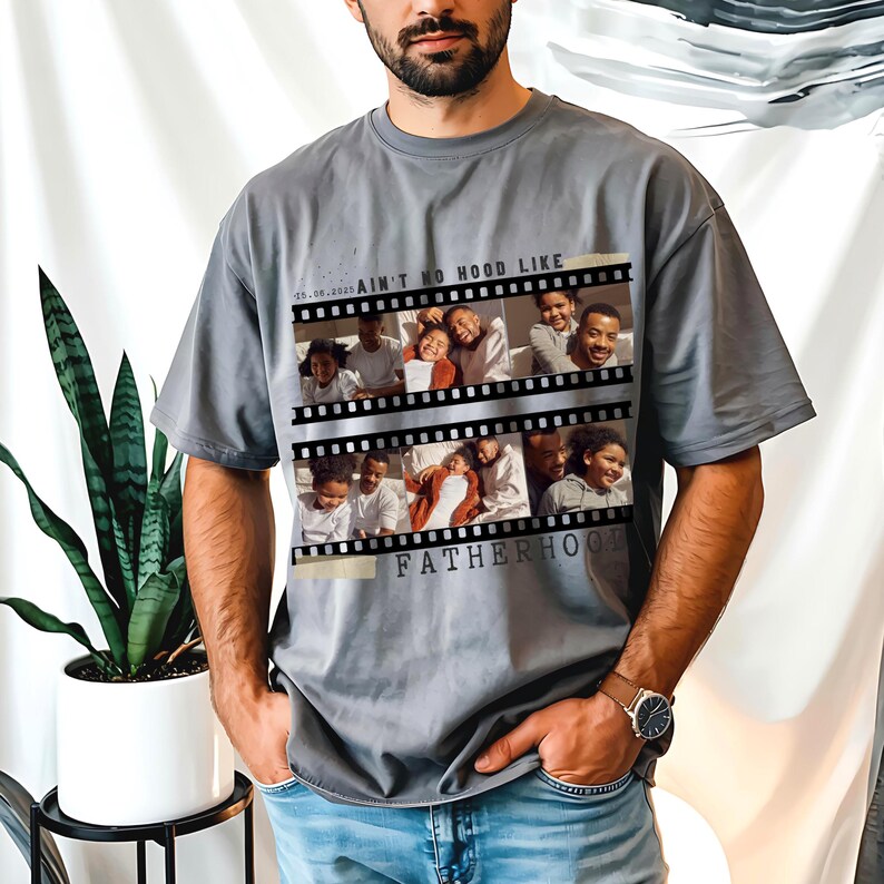 Pu&ograve; includere: T-shirt grigio con un design a striscia di pellicola che mostra foto di famiglia. Il testo sulla maglietta recita "AIN'T NO HOOD LIKE FATHERHOOD". La maglietta ha una vestibilit&agrave; ampia e maniche corte.