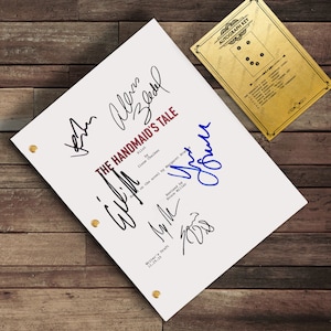 May include: A white script with the title "The Handmaid's Tale" and multiple signatures in black and blue ink. The script is secured with brass fasteners. An autograph key in gold is in the upper right corner.