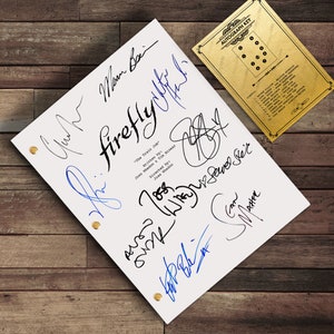 May include: A white script titled "Firefly: The Train Job" with multiple signatures in black and blue ink. A gold-coloured autograph key is in the upper right corner. The script is secured with gold-coloured fasteners.