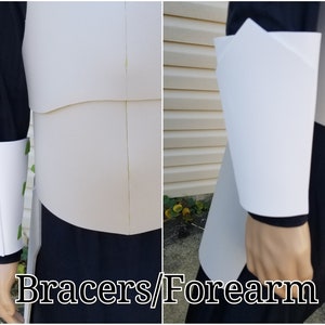 May include: White foam bracers and forearm armor for cosplay or costume making. The bracers have a simple design with a straight edge and a slight curve at the top. The forearm armor is slightly curved and has a pointed edge at the top.