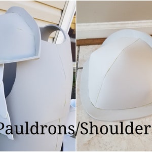 May include: Two white foam shoulder pads for a costume. The shoulder pads are shaped like a dome and have a raised edge. The text "Pauldrons/Shoulders" is written below the shoulder pads.