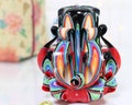 Hand Carved Candle: Black Multi-Colored Decorative Candle product logo