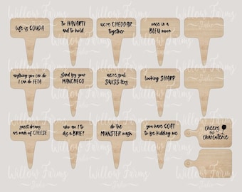 May include: A set of 12 wooden cheese-themed food picks with funny sayings. The picks are laser cut and ready to be used for a charcuterie board or wedding favors. The sayings include "Life is Gouda", "To Havarti and to hold", "Acre Cheddar together", "Once in Bleu", "Everything you can do I can do Feta", "Stand by your Manchego", "We're good Swiss-ters", "Looking Sharp", "Sweet dreams are made of cheese", "Who am I to brie?", "Do the Munster mash", "You have goat to be kidding me", and "Cheers to the charcuterie".