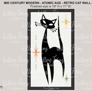 May include: Black silhouette of a cat with a long tail, standing on a white background with gold stars. The image is framed in black and has the text "Finished size is 19" H x 11" W."