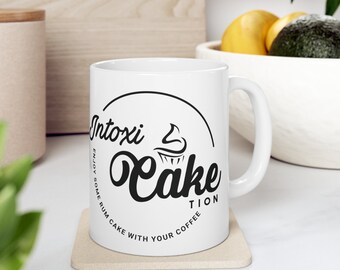 Intoxi-Cake-Tion (left hand) Ceramic Mug 11oz (logo facing out)